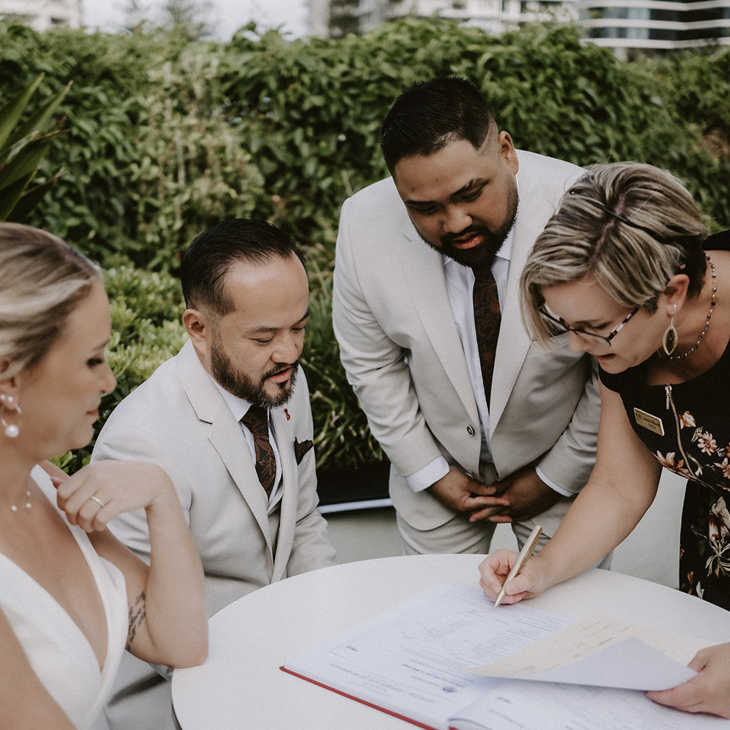 Gold Coast wedding celebrant Lauren Moore smiling with happy newlyweds