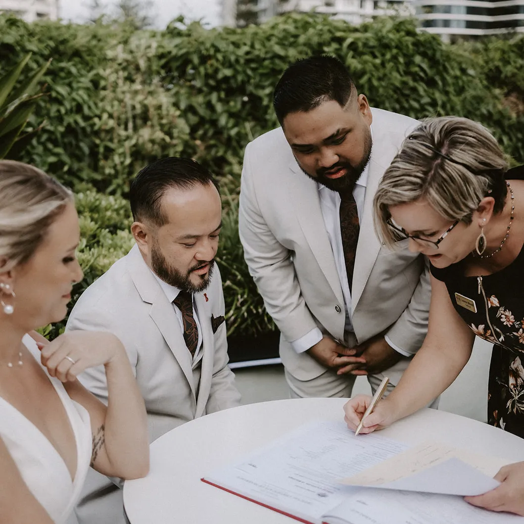 Gold Coast wedding celebrant Lauren Moore smiling with happy newlyweds