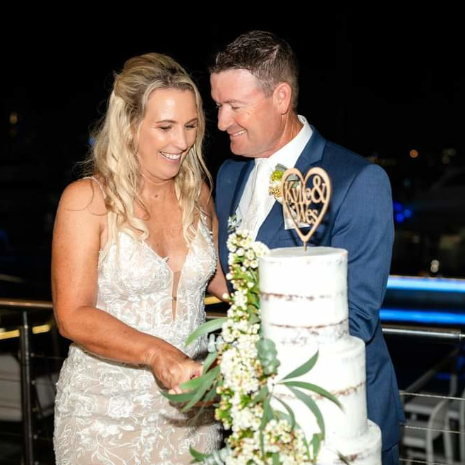 Excited newlyweds walking together after their Gold Coast beach elopement